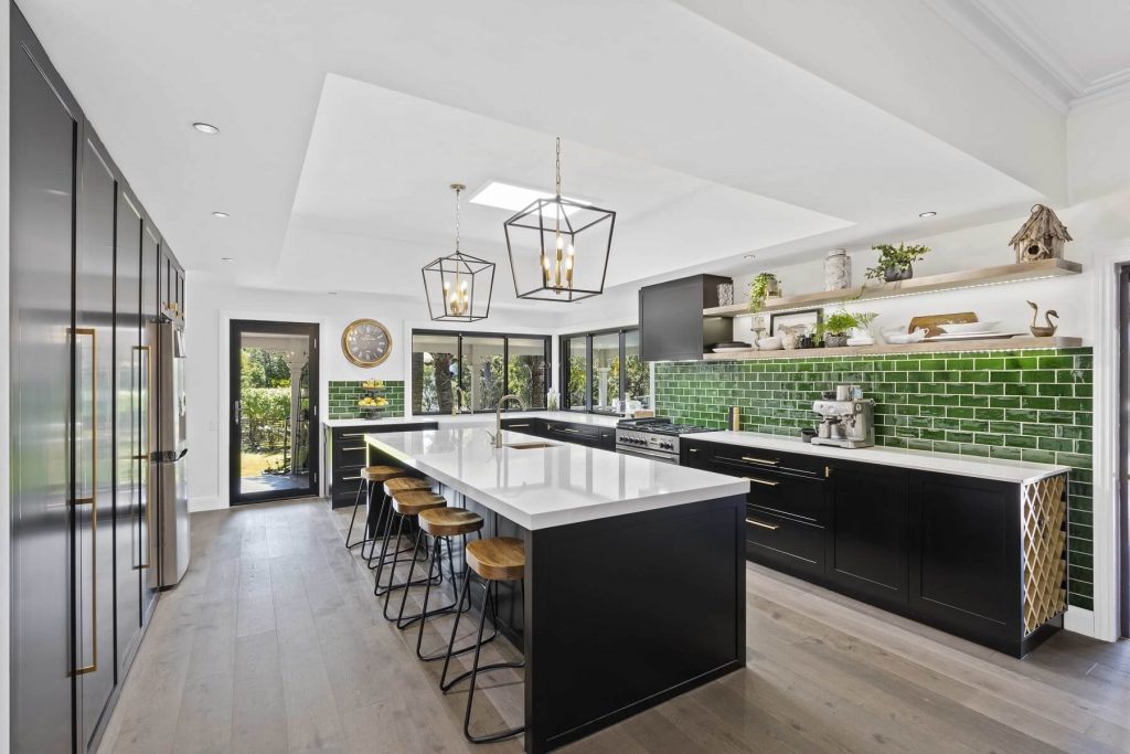 Parkwood Gold Coast Kitchen Renovation banner luxury kitchen with green tiles, black cabinets and gold coloured fittings