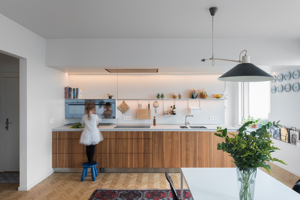 kitchen renovation along one wall with kid making food on stool