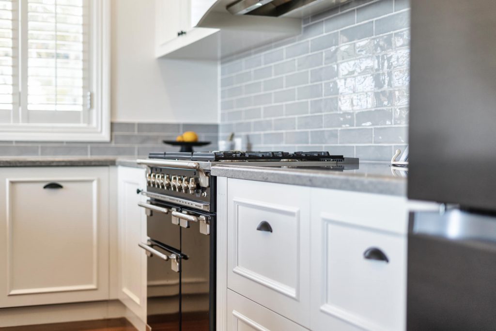 Marine Drive East Kitchen Renovation featuring modern stove and white drawer with gray break splash back