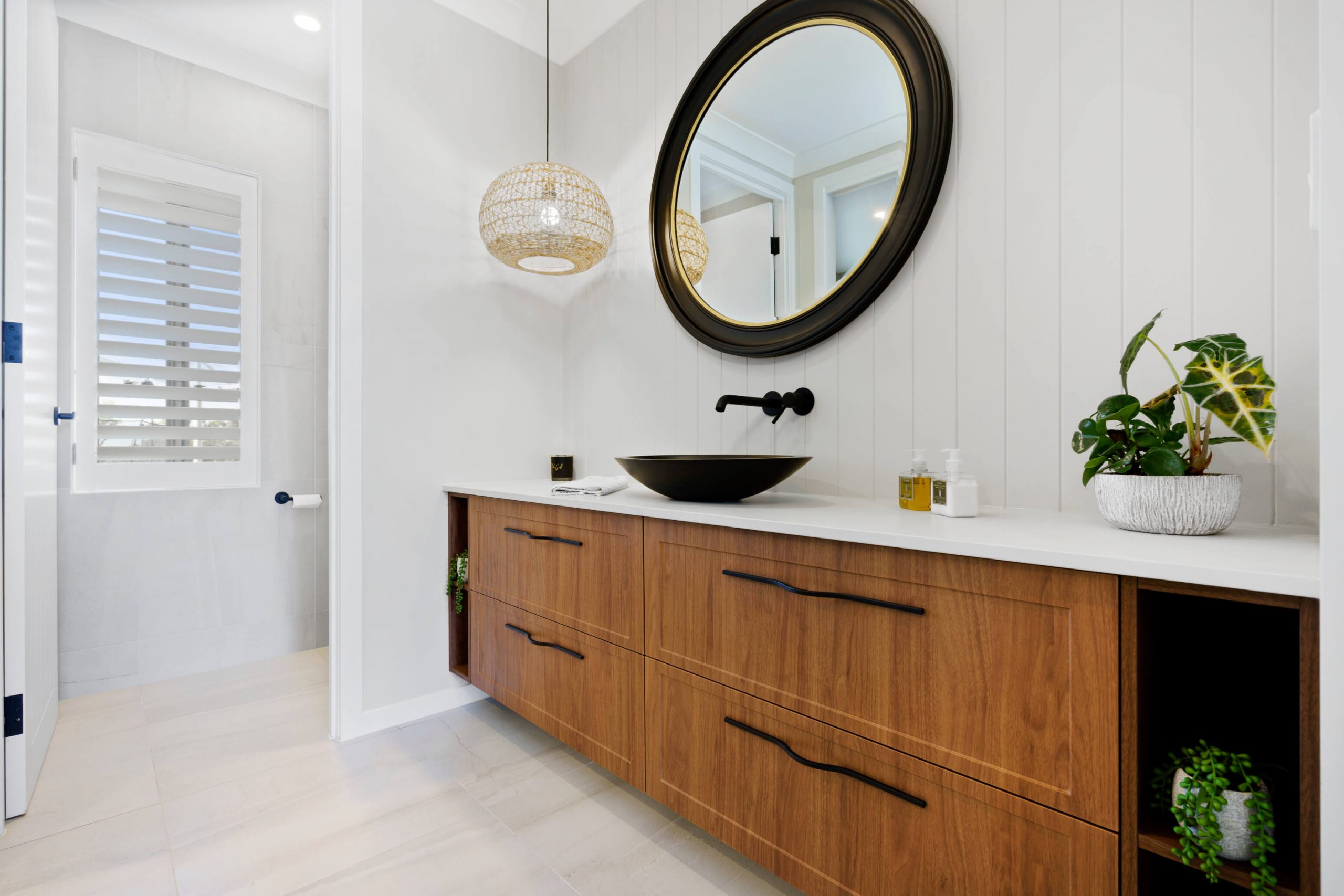bathroom with a sink, mirror, and bathtub in gold coast bathroom renovations