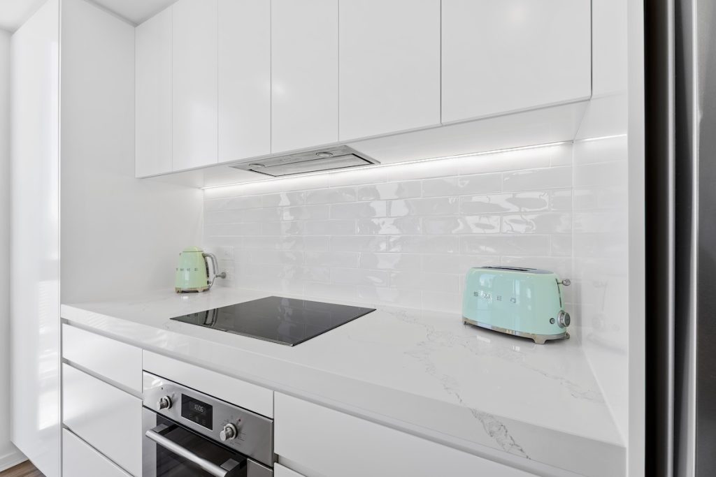 Crisp white finishes and marble benchtop with wooden floors